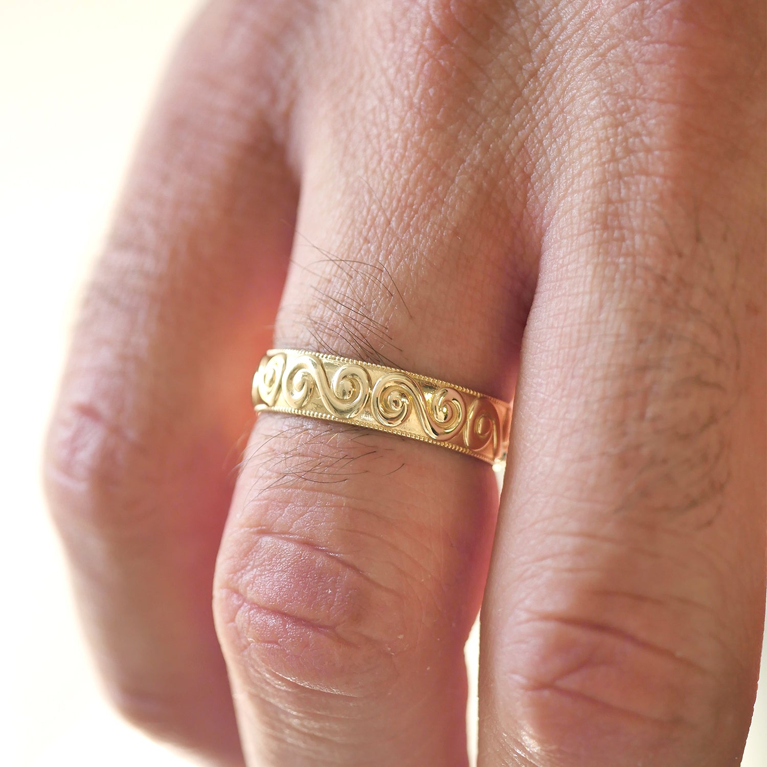 14k yellow gold close up of wide wind spiral wedding band