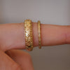 Two floral engraved wedding bands. 