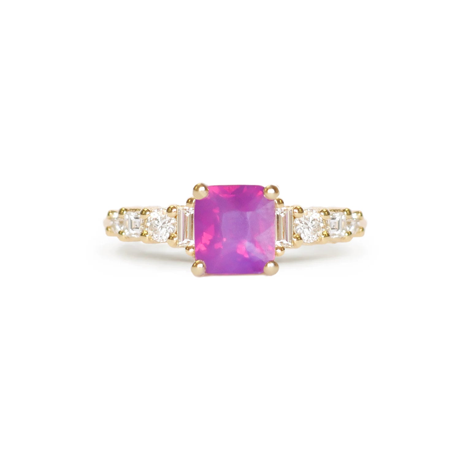 This stunning ring features a rare unheated cushion cut opalescent ruby-colored sapphire, complemented by eight natural diamonds in round, carré, and baguette shapes, offering an elegant and unique piece with vibrant color and sparkle.