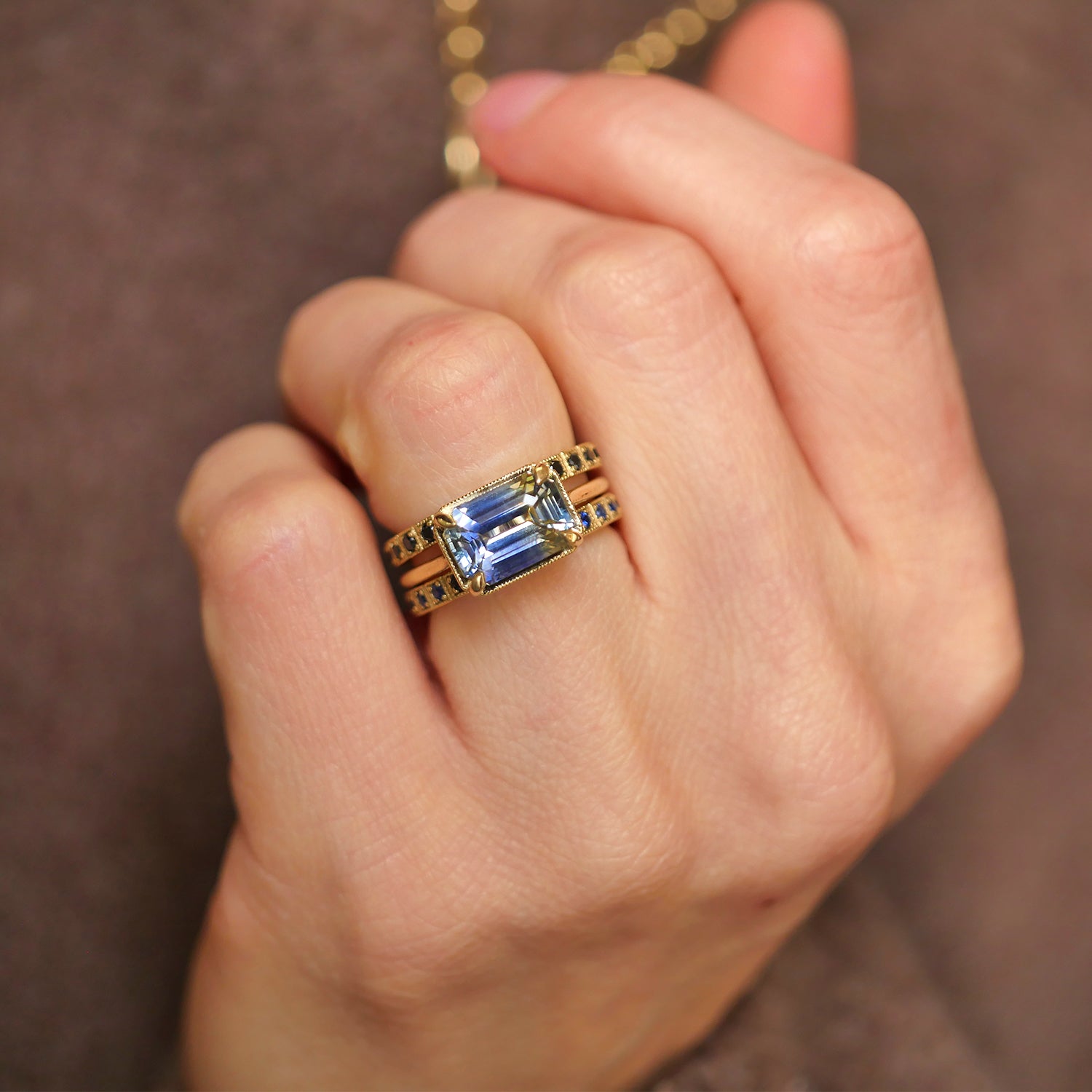 East west solitaire sapphire engagemen ring with sapphire stacked bands