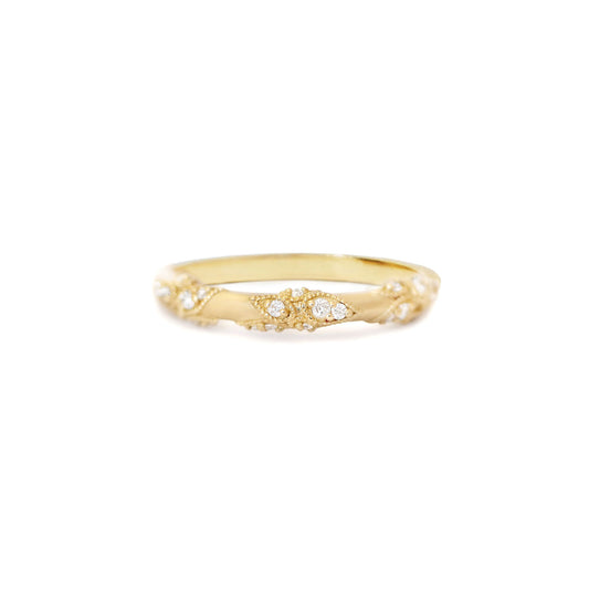 A twisted vine diamond band ring with round brilliant cut diamonds set in 14k yellow gold.