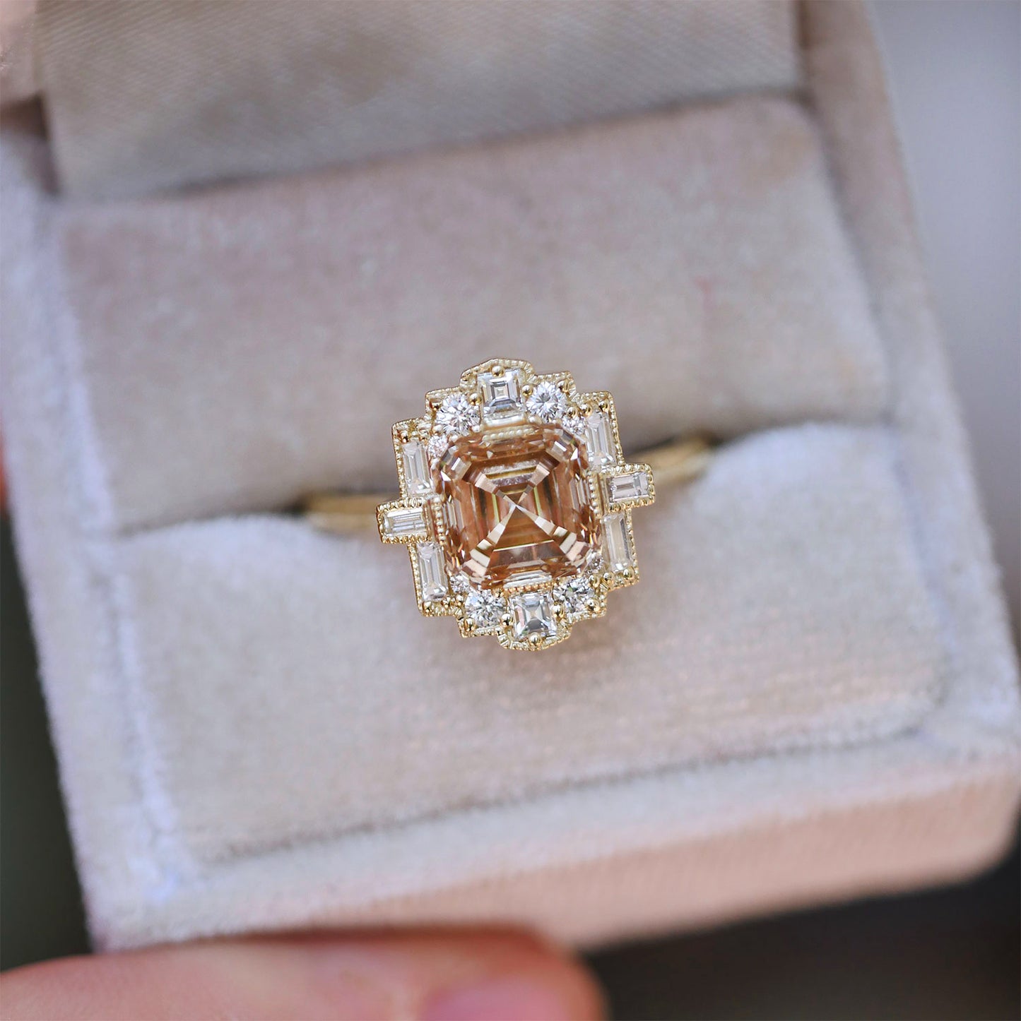 Gold ring with a central unique champagne diamond and surrounding white diamonds.