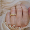Close-up of a hand wearing a 14k yellow gold nature inspired band