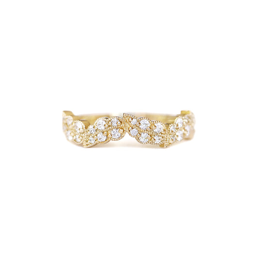 A leaf inspired ring with a series of round brilliant cut diamonds set in 14k yellow gold.