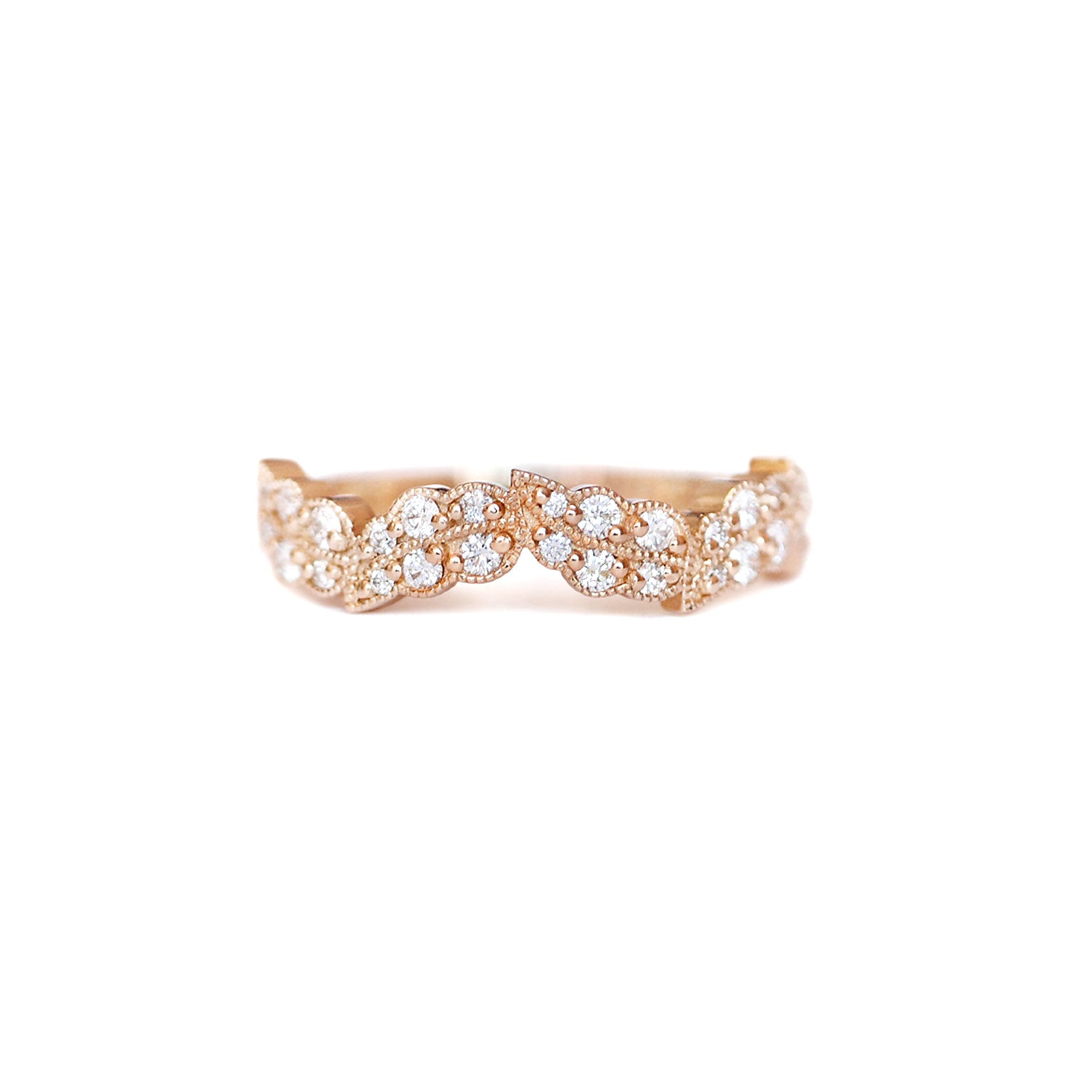 A leaf inspired band with a series of round brilliant cut diamonds set in 14k yellow gold.