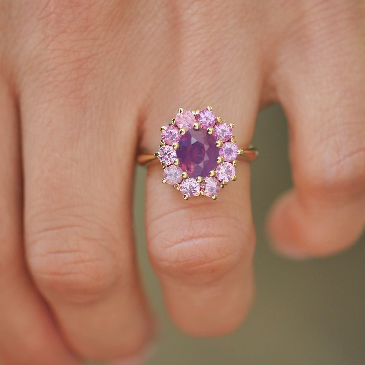 woman wearing unique and one of a kind inspired cluster ring with purple and pink sapphires