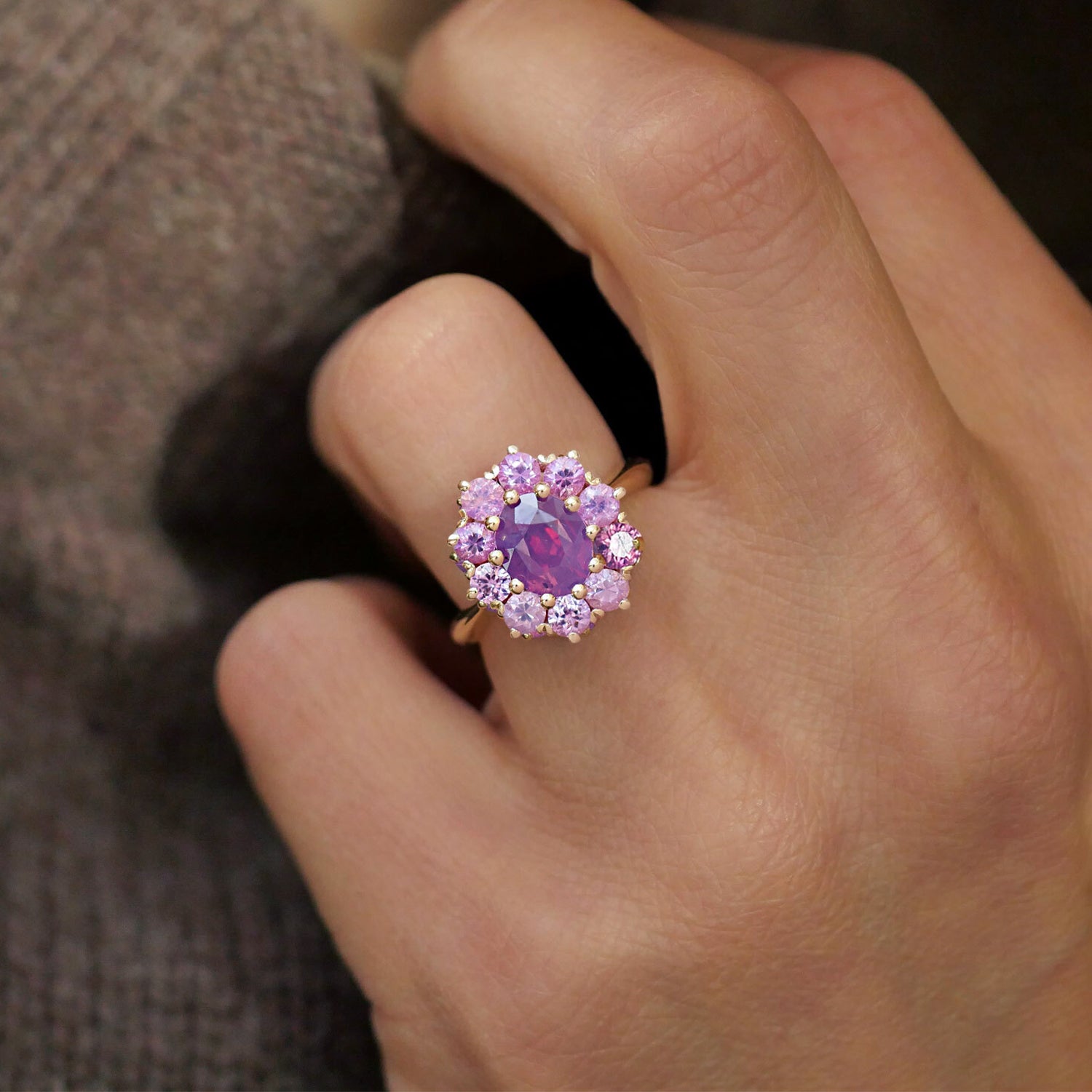 woman wearing vintage inspired cluster ring with purple and pink sapphires