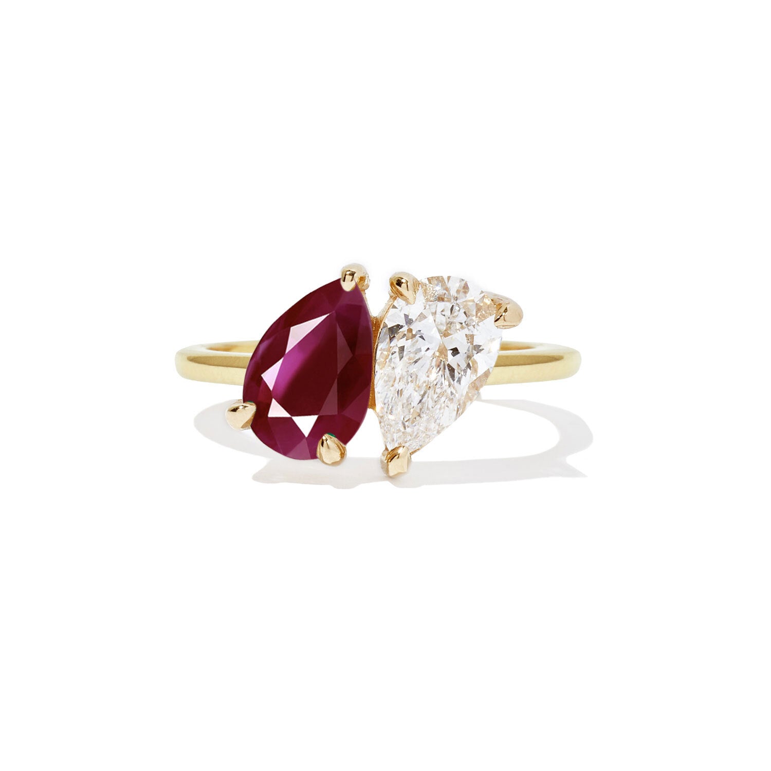 This toi et moi ring combines the fiery passion of a ruby with the timeless elegance of a pear-shaped diamond, creating a stunning symbol of love and devotion.