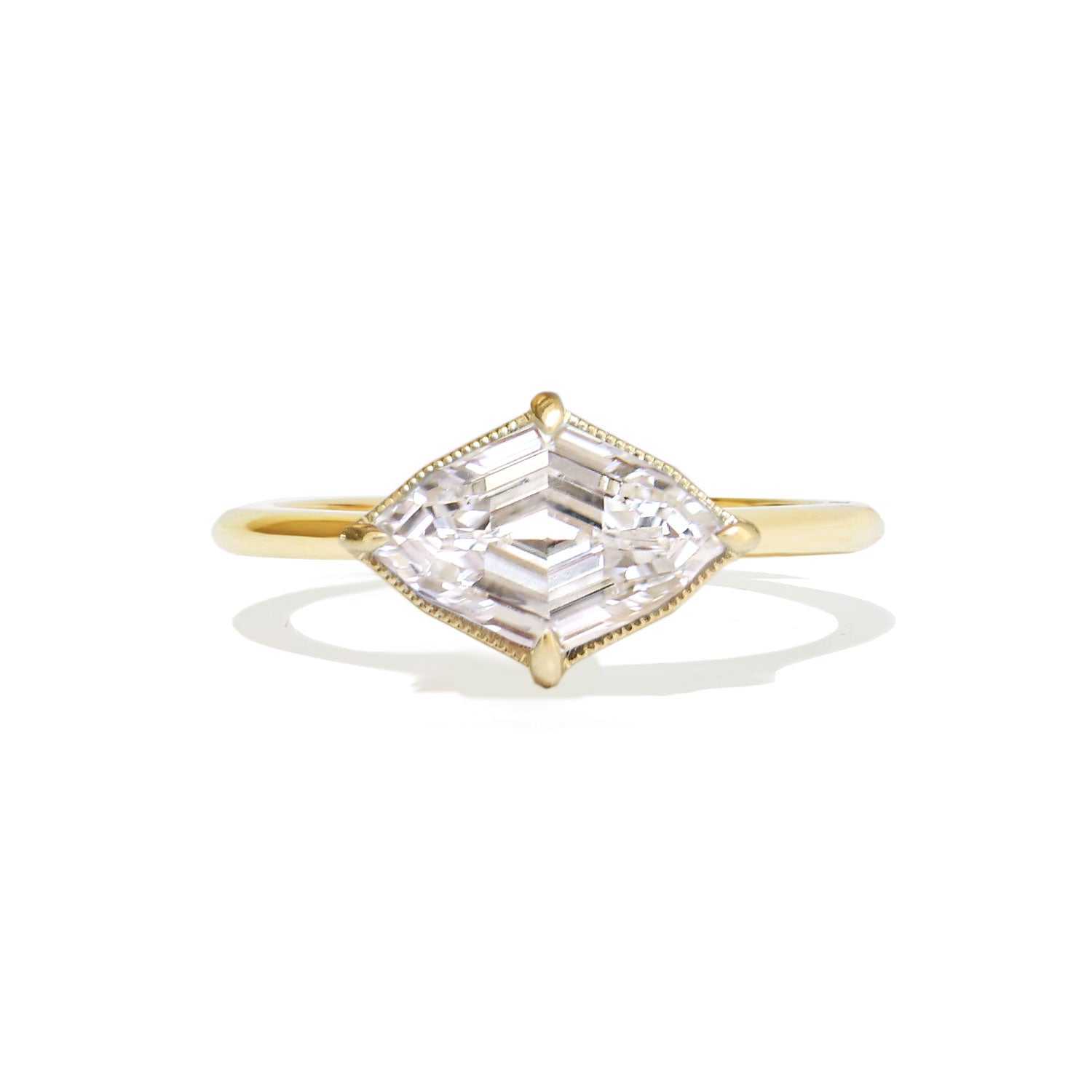 A brilliant lozenge cut diamond at the center of this elegant engagement ring.