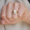 The cushion cut diamond is set within a split shank band, adding a touch of glamour and unique flair to this timeless solitaire ring. Stacked with a diamond contour ring.