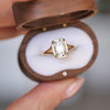 With its sleek, split shank design, this ring draws the eye to the sparkling cushion cut diamond, creating a captivating focal point of brilliance.