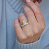 The clean lines of the split shank setting highlight the brilliant lab-grown emerald cut diamond, perfectly paired with a diamond stacking band to create a refined and radiant engagement ring set.