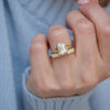 A striking lab-grown emerald cut diamond is elegantly placed in a split shank setting, paired with a shimmering diamond stacking band that adds layers of sparkle and sophistication for a modern, yet timeless, look.