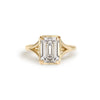 A stunning lab-grown emerald cut diamond sits beautifully in a split shank setting.