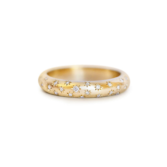 Gold ring with embedded diamonds on engraved stars