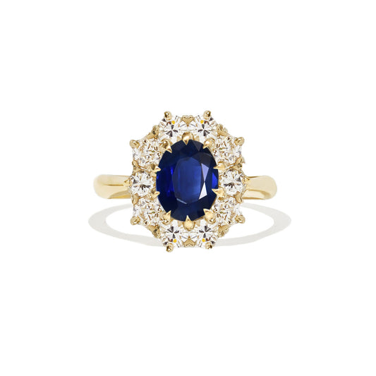 A yellow gold blue sapphire and diamond cluster ring.