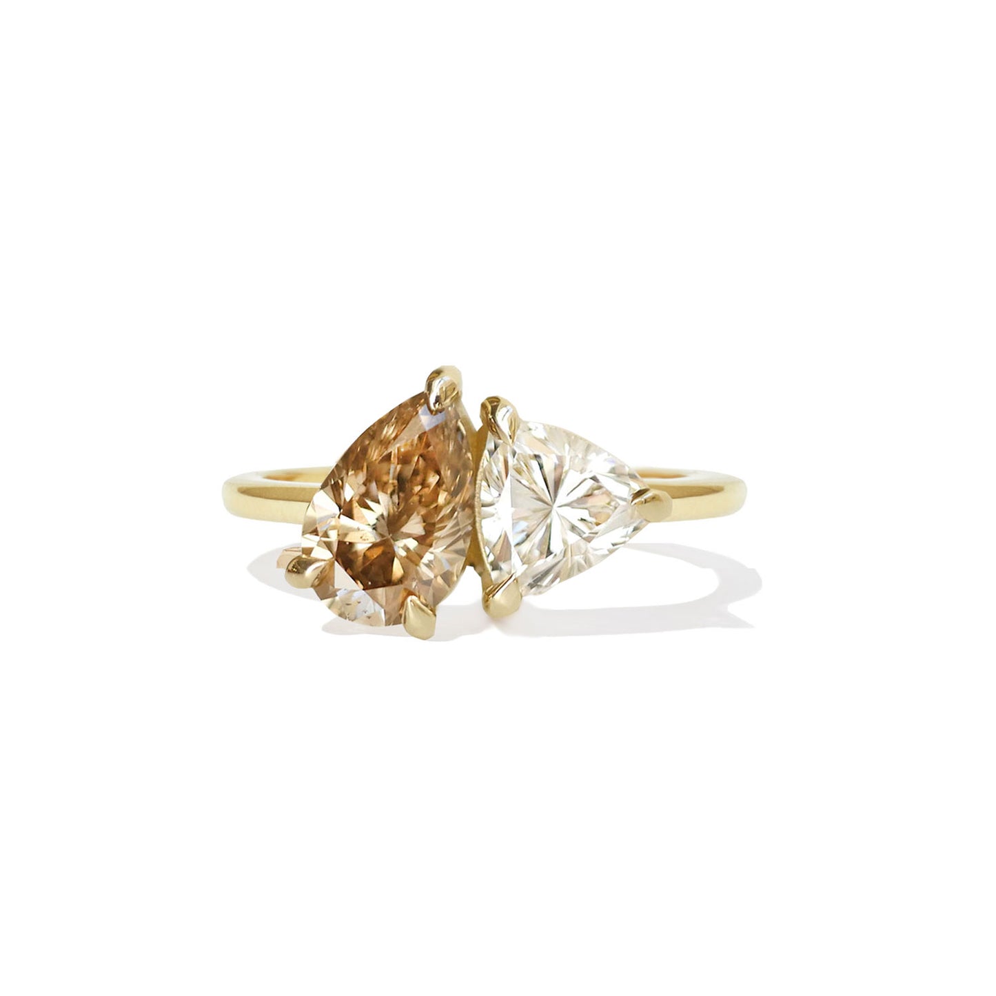 This ring features a stunning champagne pear diamond and a striking trillion diamond, beautifully representing the union of two distinct yet complementary souls.