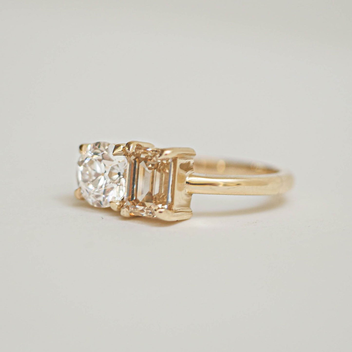 The rich, golden hue of the champagne diamond is perfectly complemented by the brilliance of the round diamond, making this ring an exquisite symbol of love and harmony.