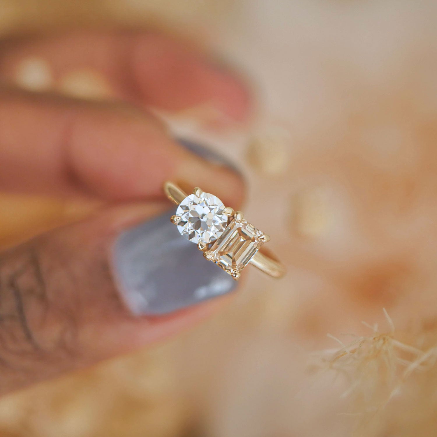 Set side by side, the champagne and round diamonds reflect light beautifully, offering a captivating visual balance in this unique and elegant design.