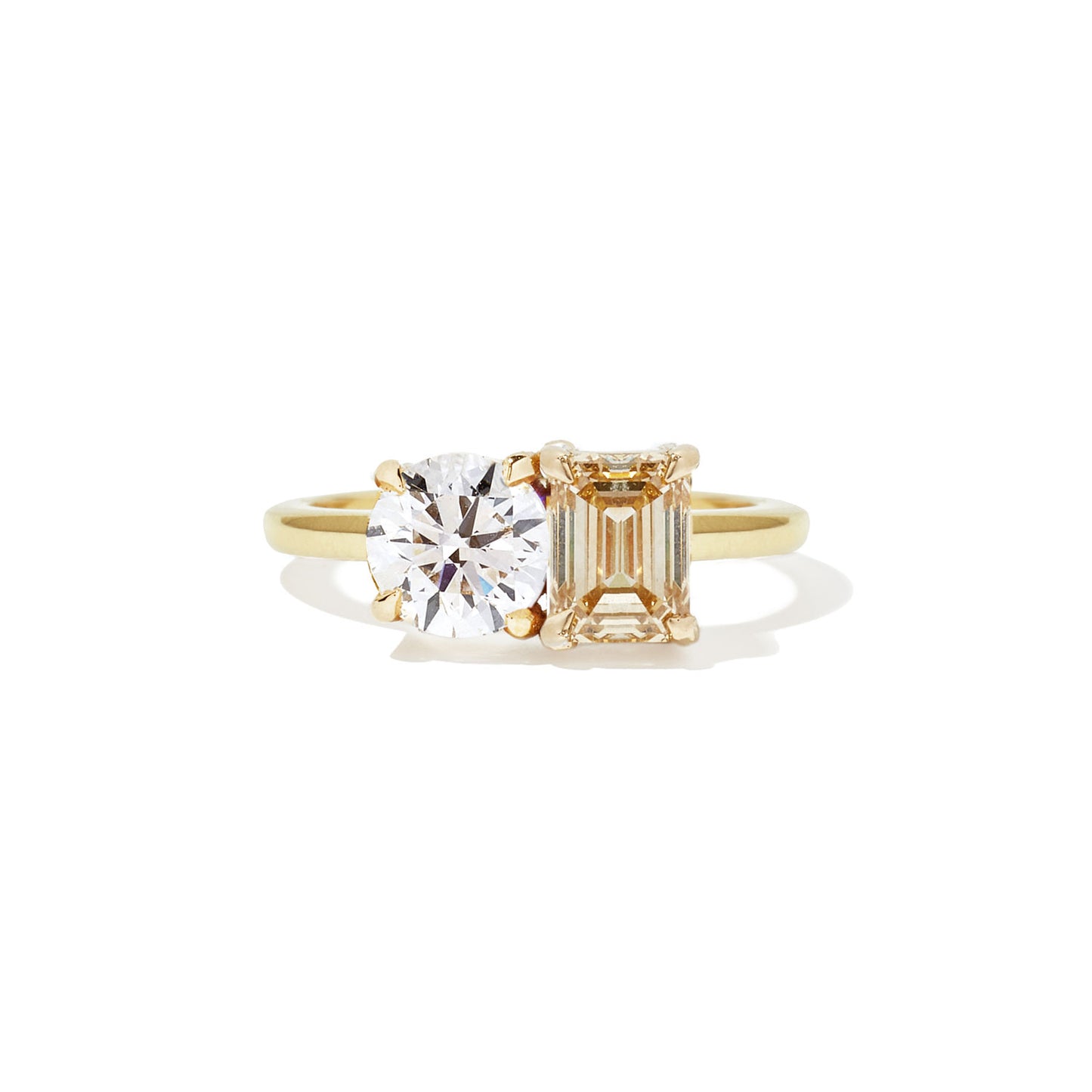 This ring features a dazzling champagne diamond paired with a classic round diamond, creating a stunning contrast of warm elegance and timeless sparkle.