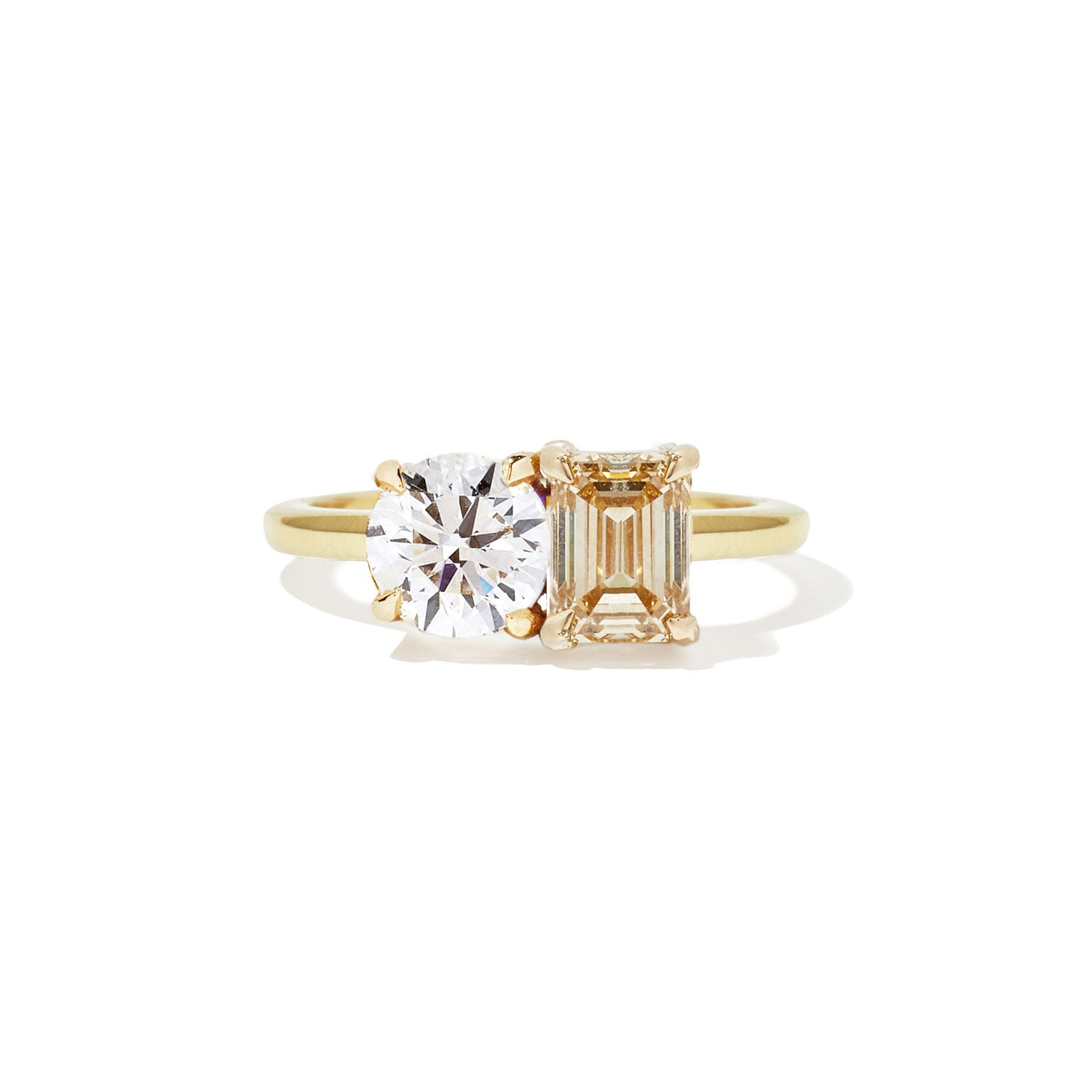 This ring features a dazzling champagne diamond paired with a classic round diamond, creating a stunning contrast of warm elegance and timeless sparkle.