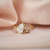This exquisite ring pairs a sparkling pear diamond with a warm champagne emerald, offering a unique and elegant take on the traditional toi et moi design, perfect for an unforgettable romantic gesture.