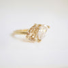 The soft, golden hue of the pear-shaped champagne diamond adds a touch of sophistication, making this ring a unique and timeless expression of love and devotion.