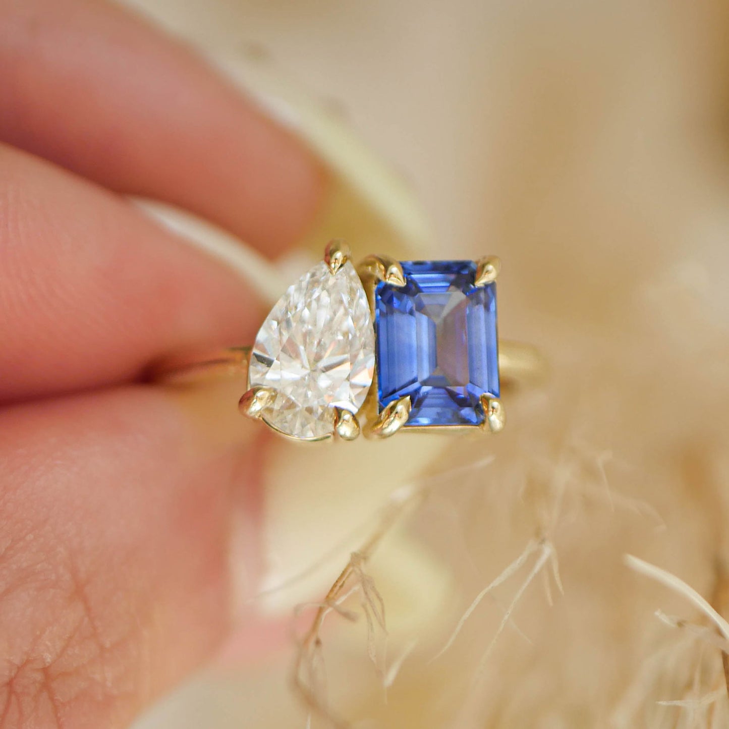 With its striking combination of gemstones, this Sapphire, Emerald, and Pear Diamond Toi et Moi ring symbolizes the harmony between two people, each bringing their own beauty to the relationship.