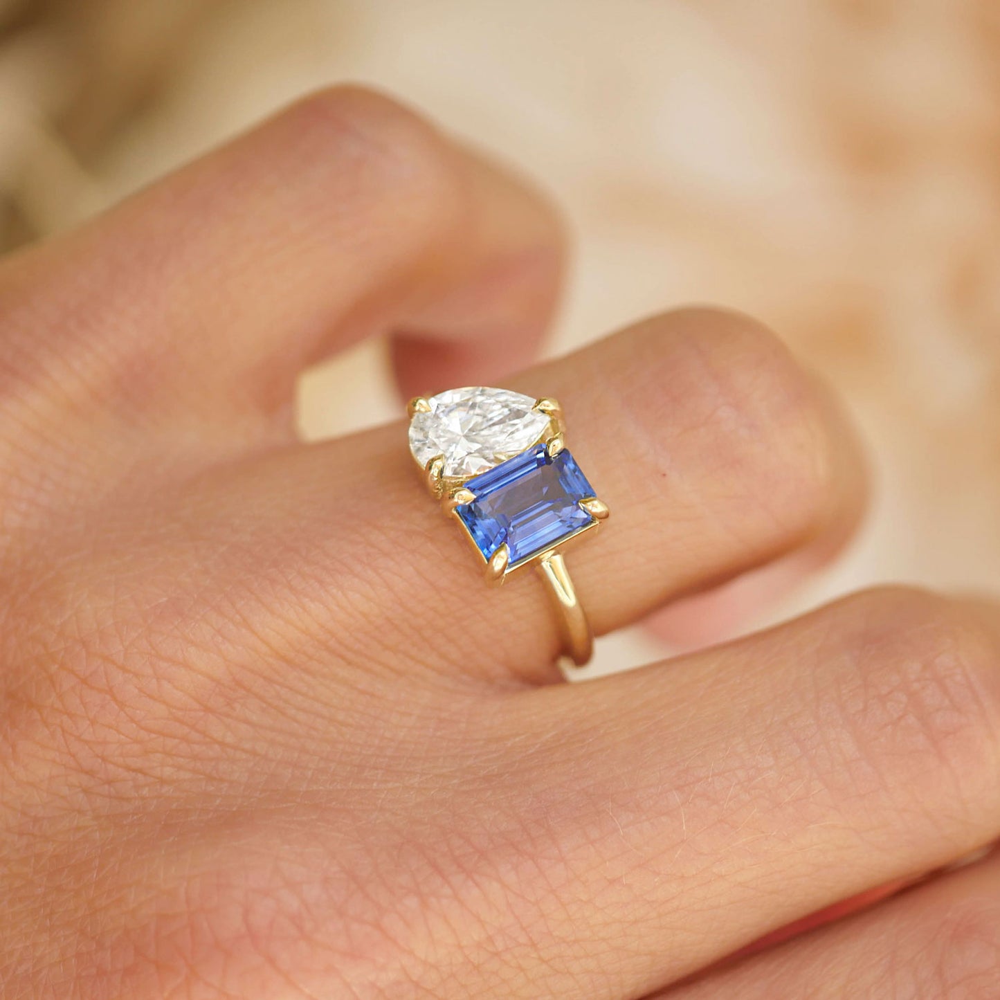 The vivid sapphire and emerald in this design create a mesmerizing contrast, while the pear-shaped diamond adds a touch of light and elegance to this one-of-a-kind piece.