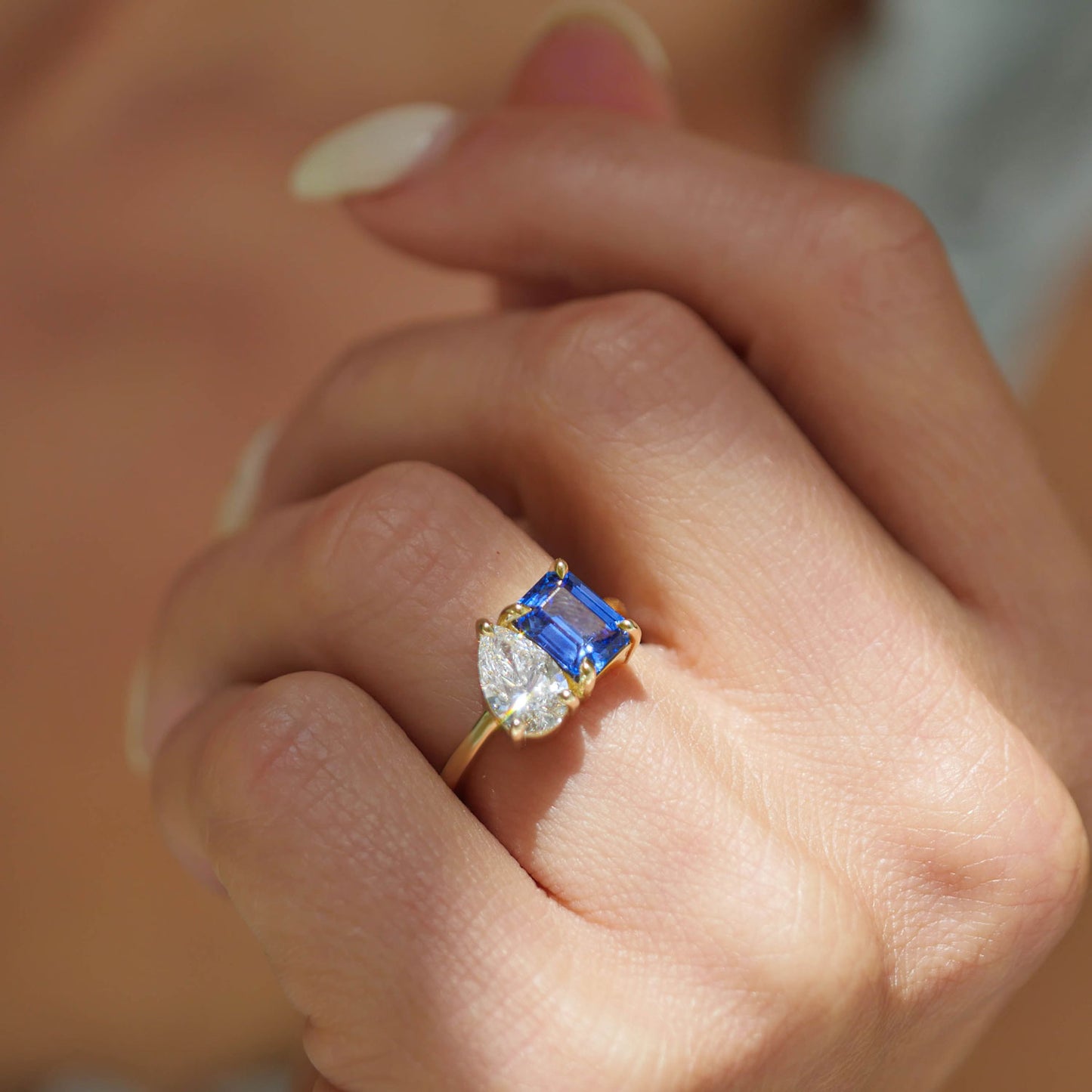 This ring celebrates the uniqueness of love with its vibrant gemstones: the sapphire for loyalty, the emerald for growth, and the pear diamond for timeless commitment.